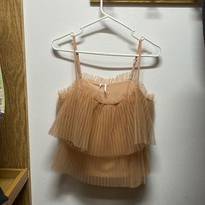 Think New Year’s eve - a fun & flirty camisole atop metallic faux leather pants